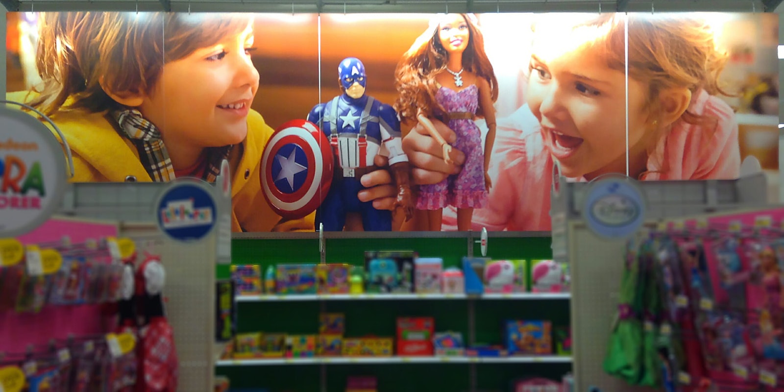 wide angle shot of toy store with poster of children playing with figurines
