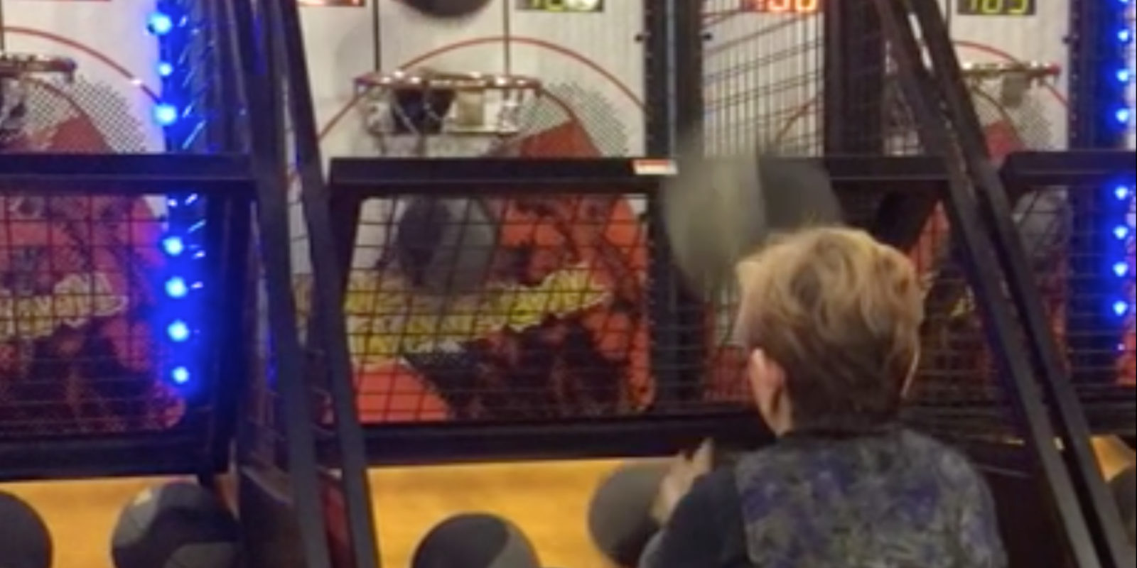woman beats arcade basketball