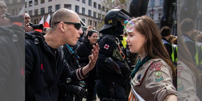 A Czech scout stands firm as a neo-Nazi talks at her during a demonstration in Brno, Czech Republic.