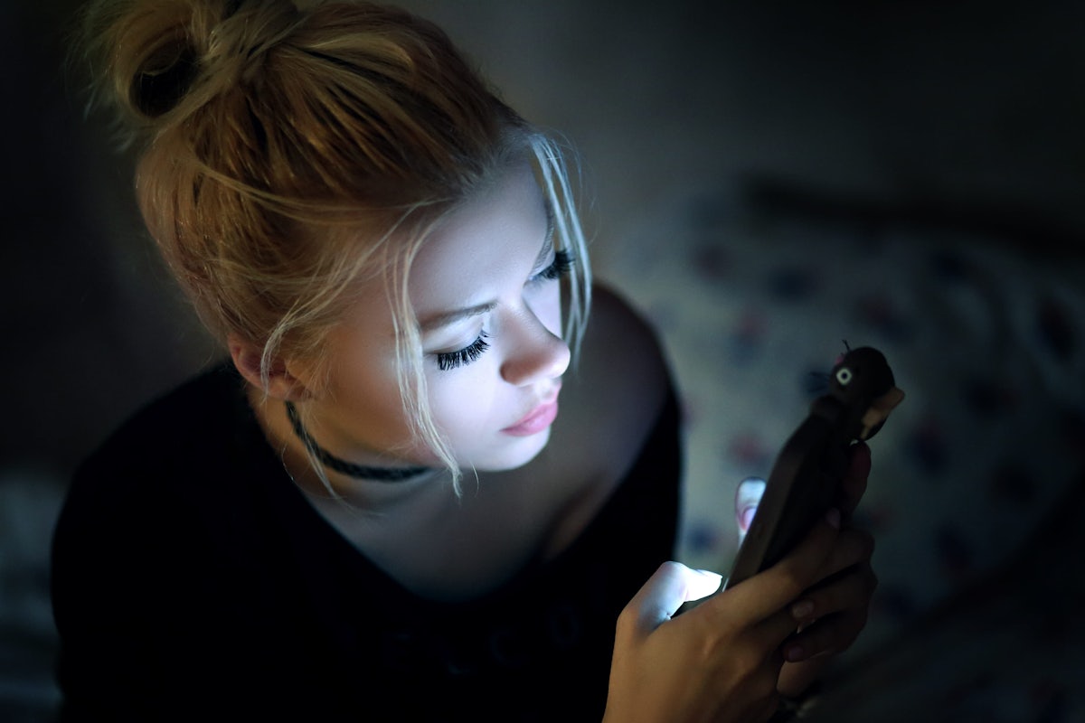 woman in dark on phone