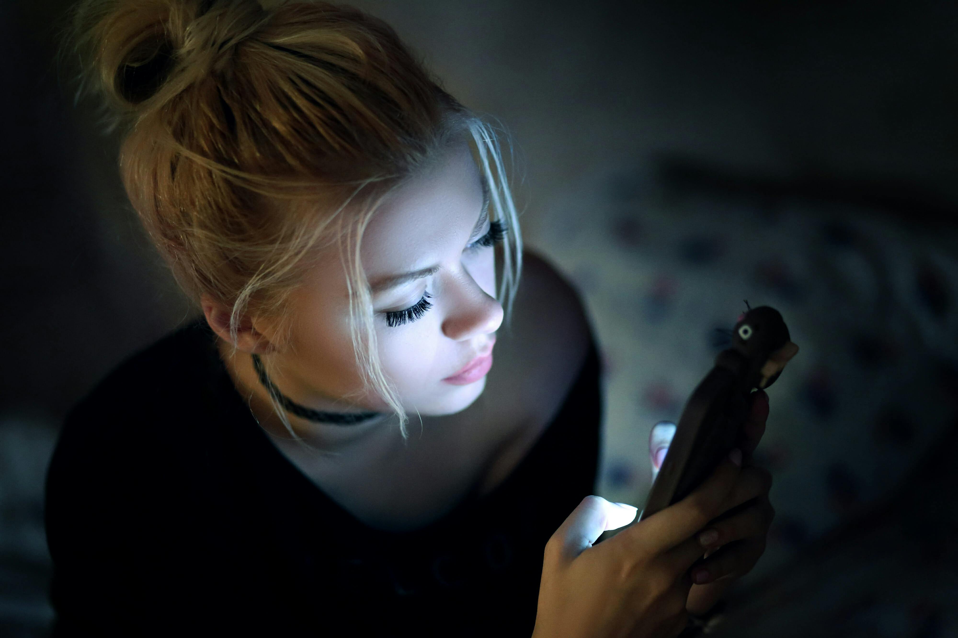 woman in dark on phone