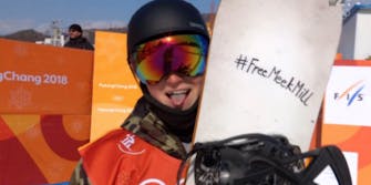 Tit Stante holds up a snowboard with #FreeMeekMill written on it in Sharpie