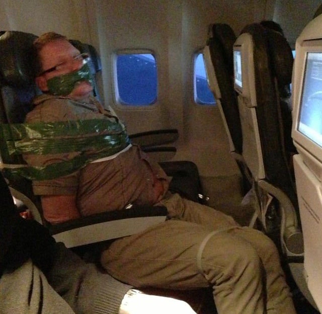 Reddit snapped this photo of a drunk Icelandair passenger taped to his