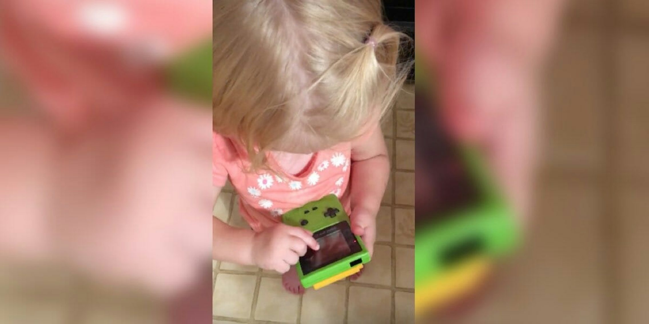 little girl tries to figure out game boy