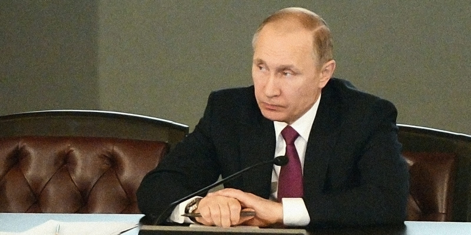 Vladimir Putin sitting at desk