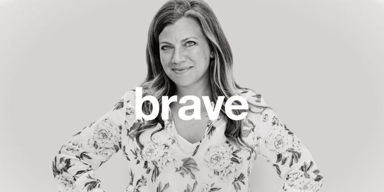 A woman stands with her hands on her hips and the word 'brave' superimposed across her chest