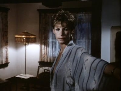 A woman stands in a robe in a scene from love letters