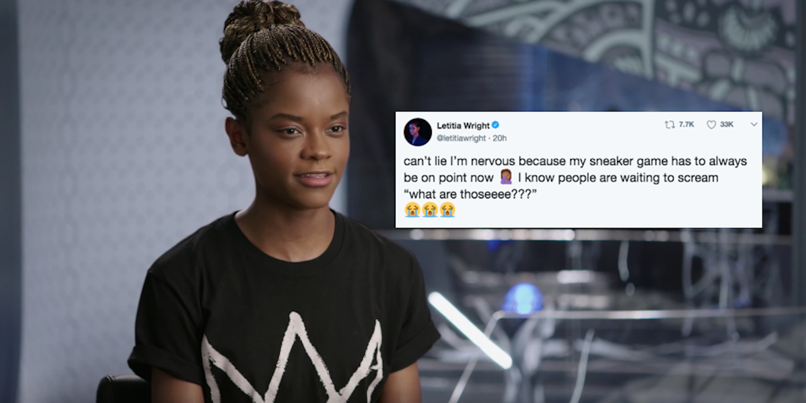 Letitia Wright sits in a black teeshirt with her hair in a bun
