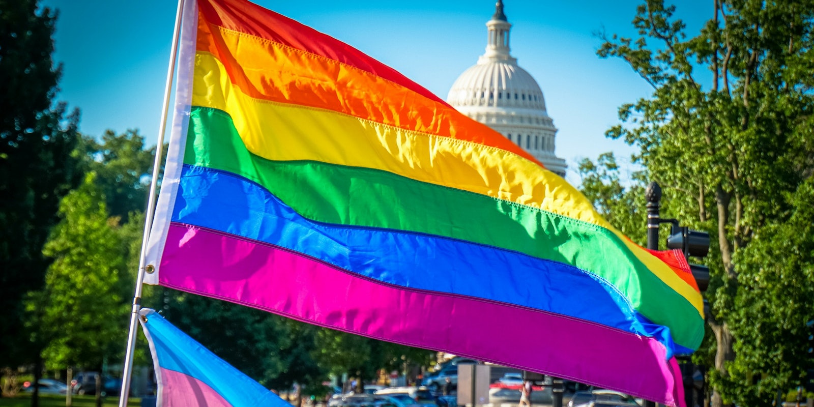 The LGBTQ flag flyig in front of the U.S. capitol building.