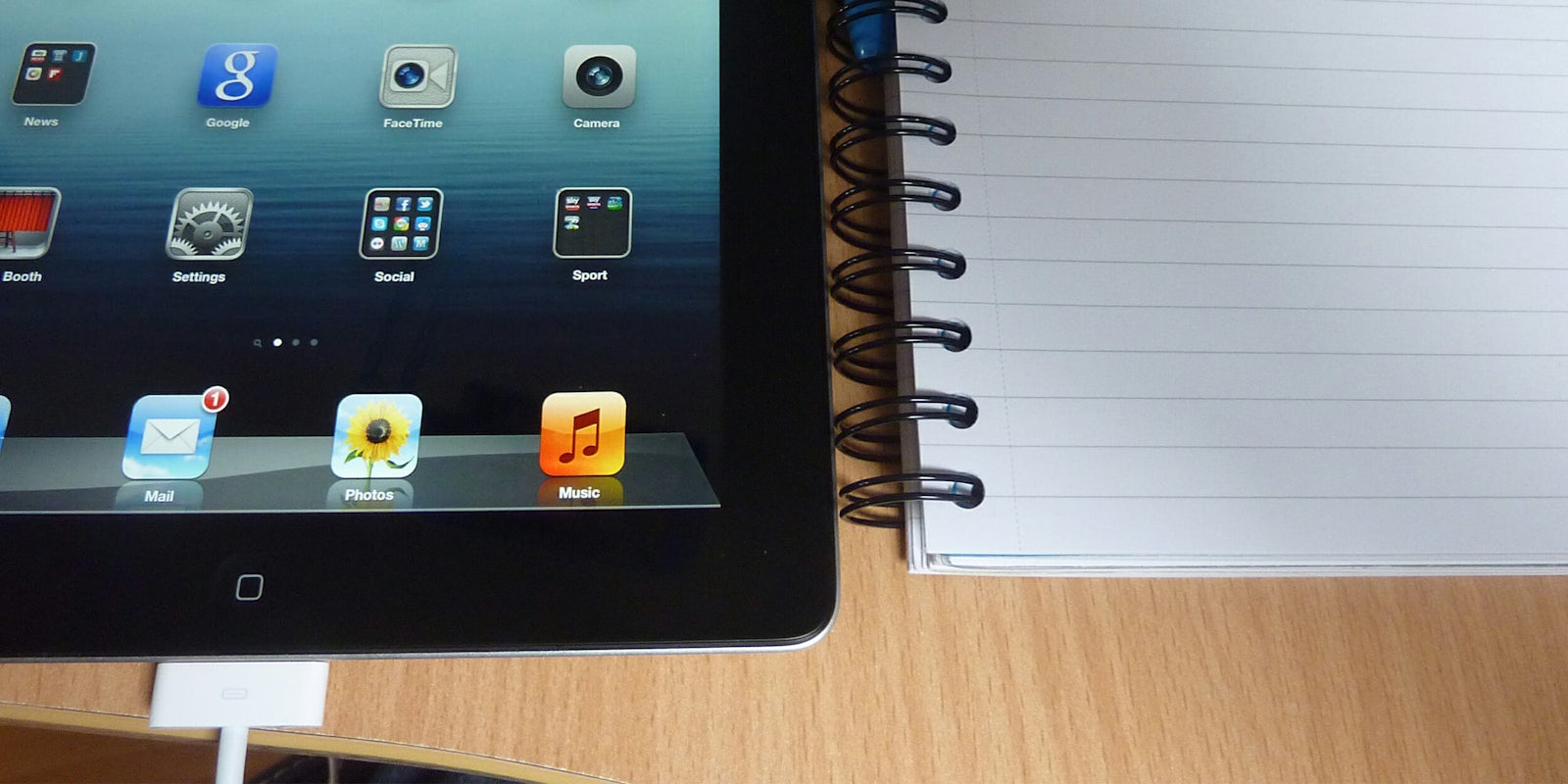 iPad and notebook on a school desk