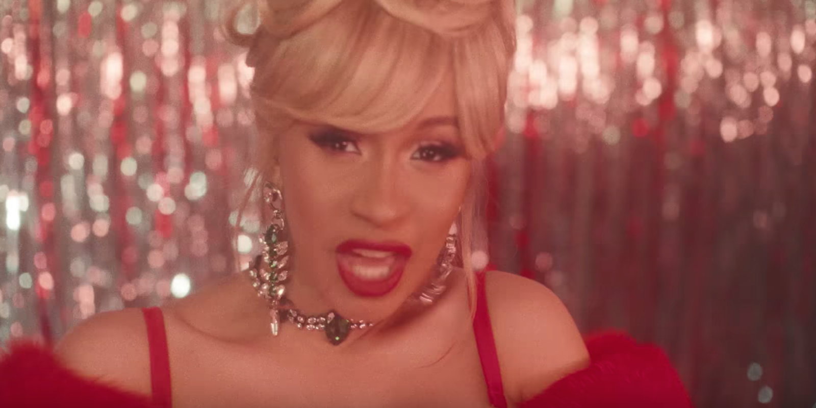 Cardi B in a red gown and diamond earrings