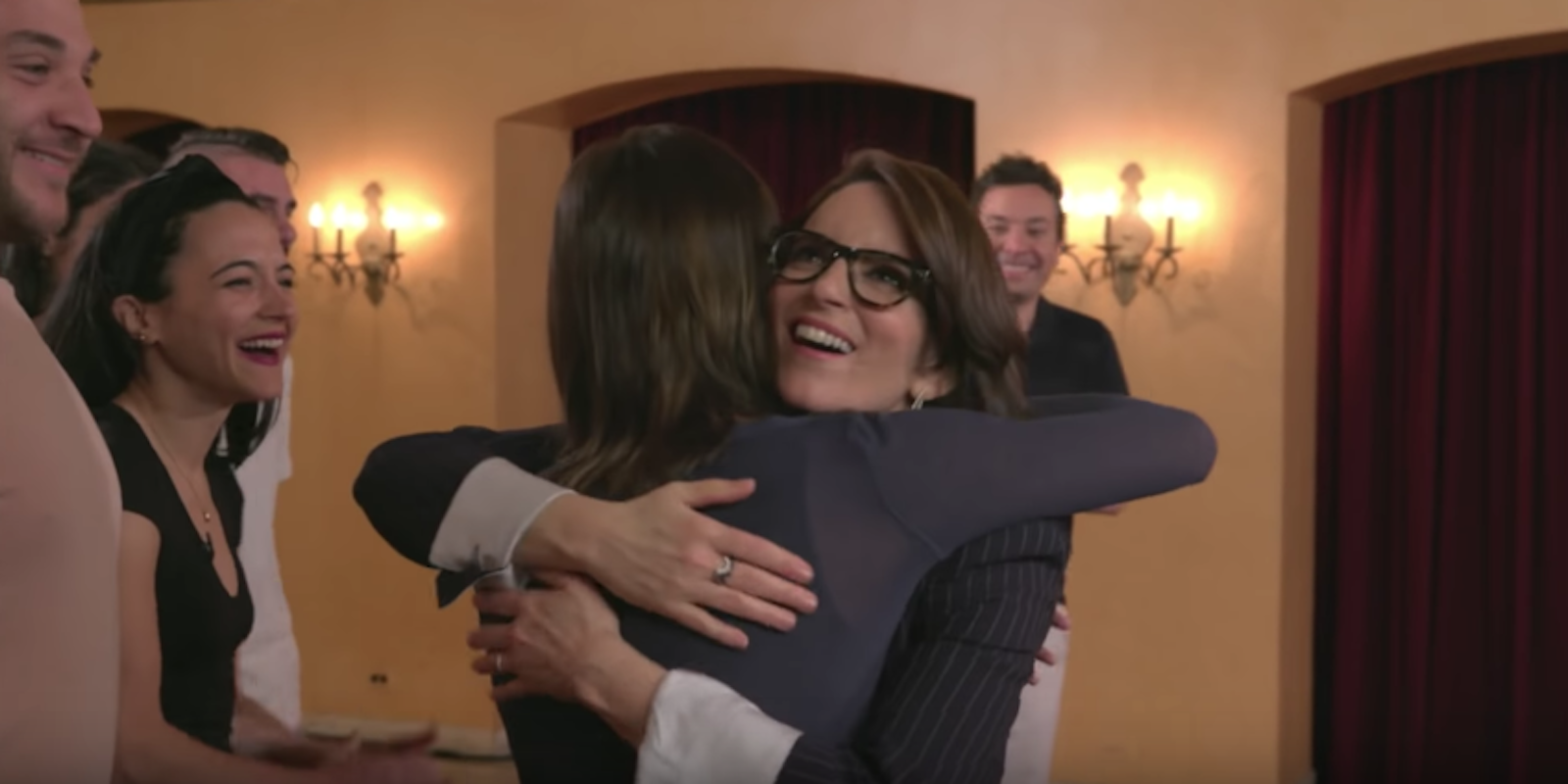 Tina Fey hugs a fan while smiling