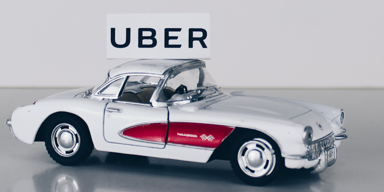 Uber logo above a toy car
