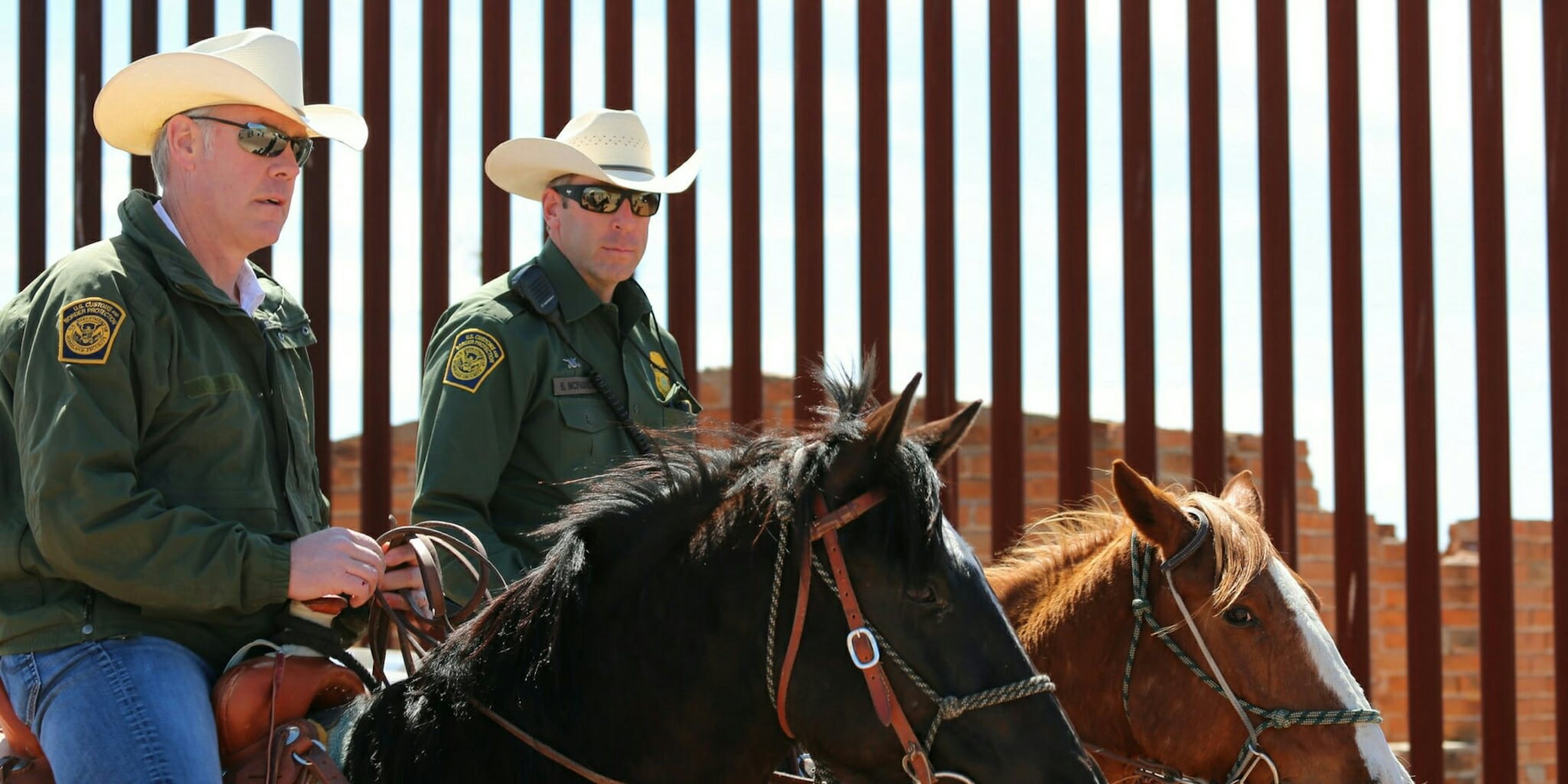 U.S. Department of Interior Secretary Ryan Zinke, left, and an official with the U.S. Border Patrol taking a horseback ride along the U.S.- Mexico border in Arizona.