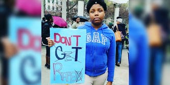 Woman holding don't get raped sign