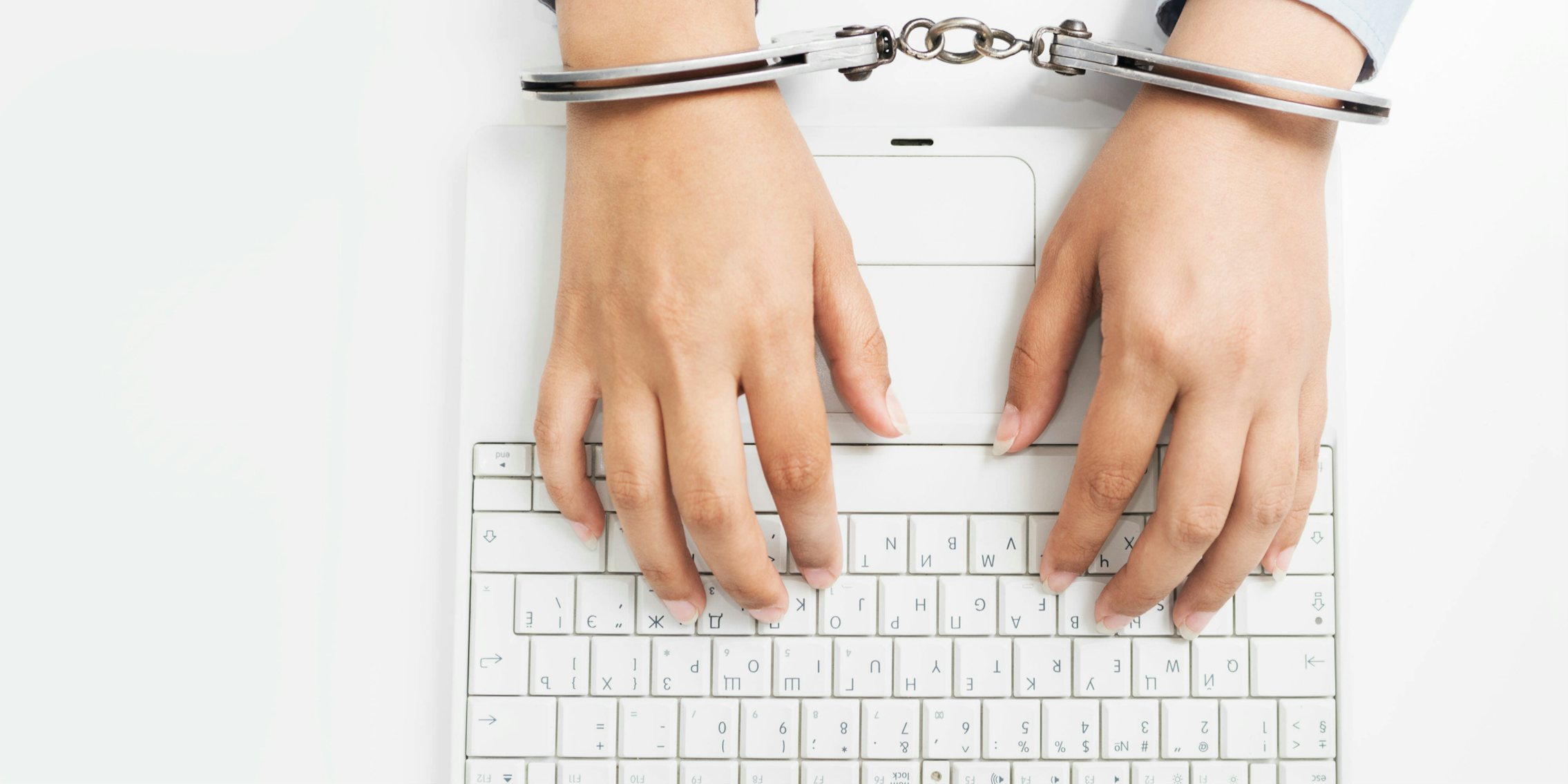 internet censorship typing on computer while handcuffed