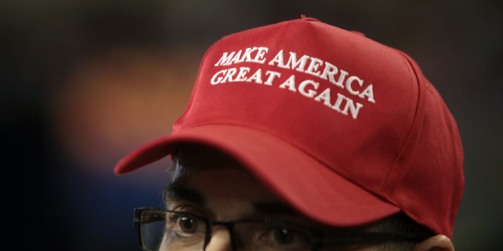 A man wearing a red 'Make America Great Again' hat.