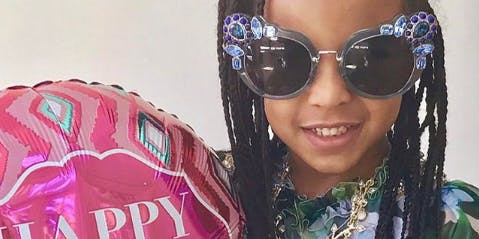 Blue Ivy Carter holds a "Happy Mother's Day" balloon