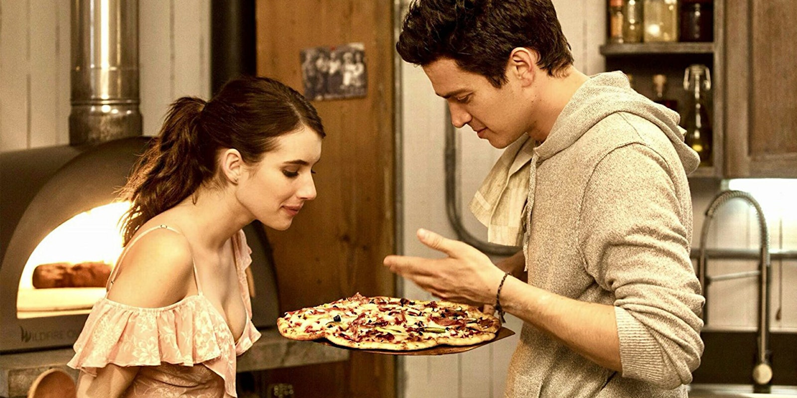 Hayden Christensen and Emma Roberts examining pizza in Little Italy