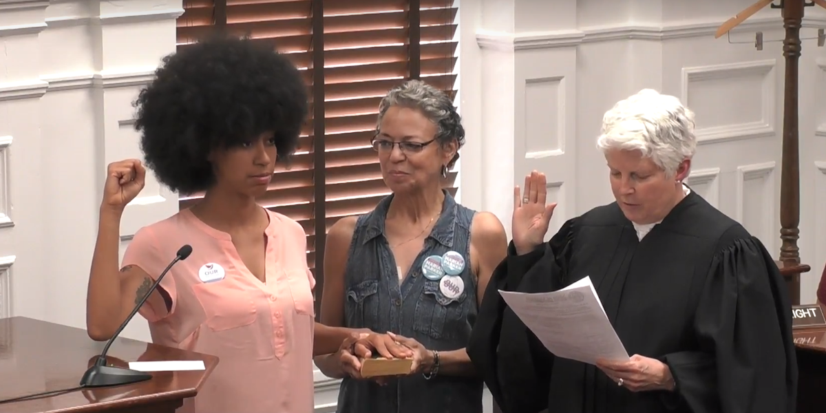 With her right hand on The Autobiography of Malcolm X and her left hand raised in a fist, Mariah Parker took her oath of office with a celebration of black power.