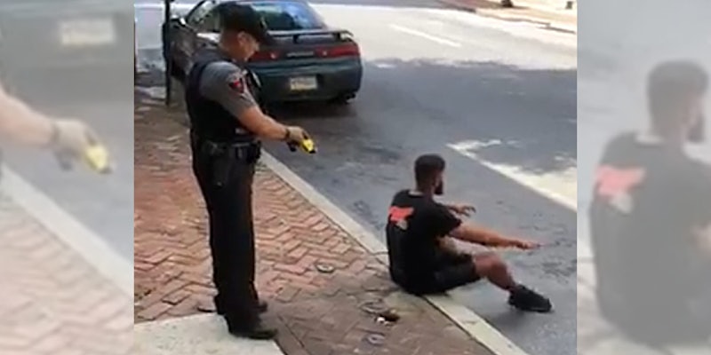 police taser man sitting on curb