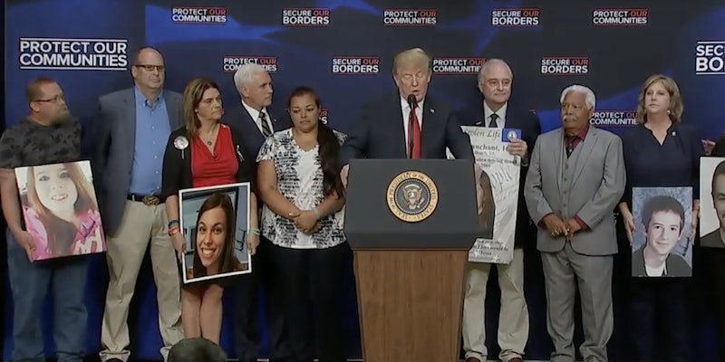 Trump autographs the photos of people whose deaths were highlighted at the White House's 'Angel Families' event.