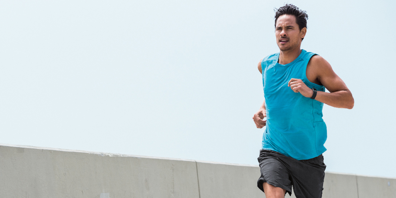 Man wearing activity tracker while running
