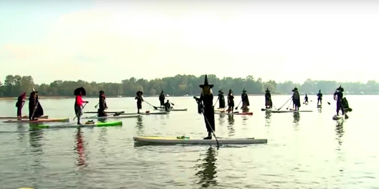 Witches paddleboarding in Oregon.