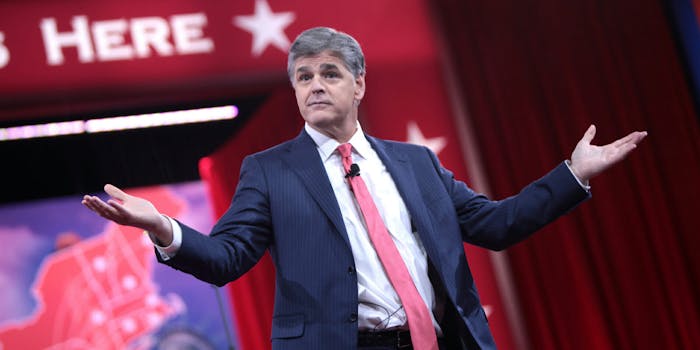Fox News pundit Sean Hannity appeared on stage with President Donald Trump at a rally on Monday despite saying he wouldn't.
