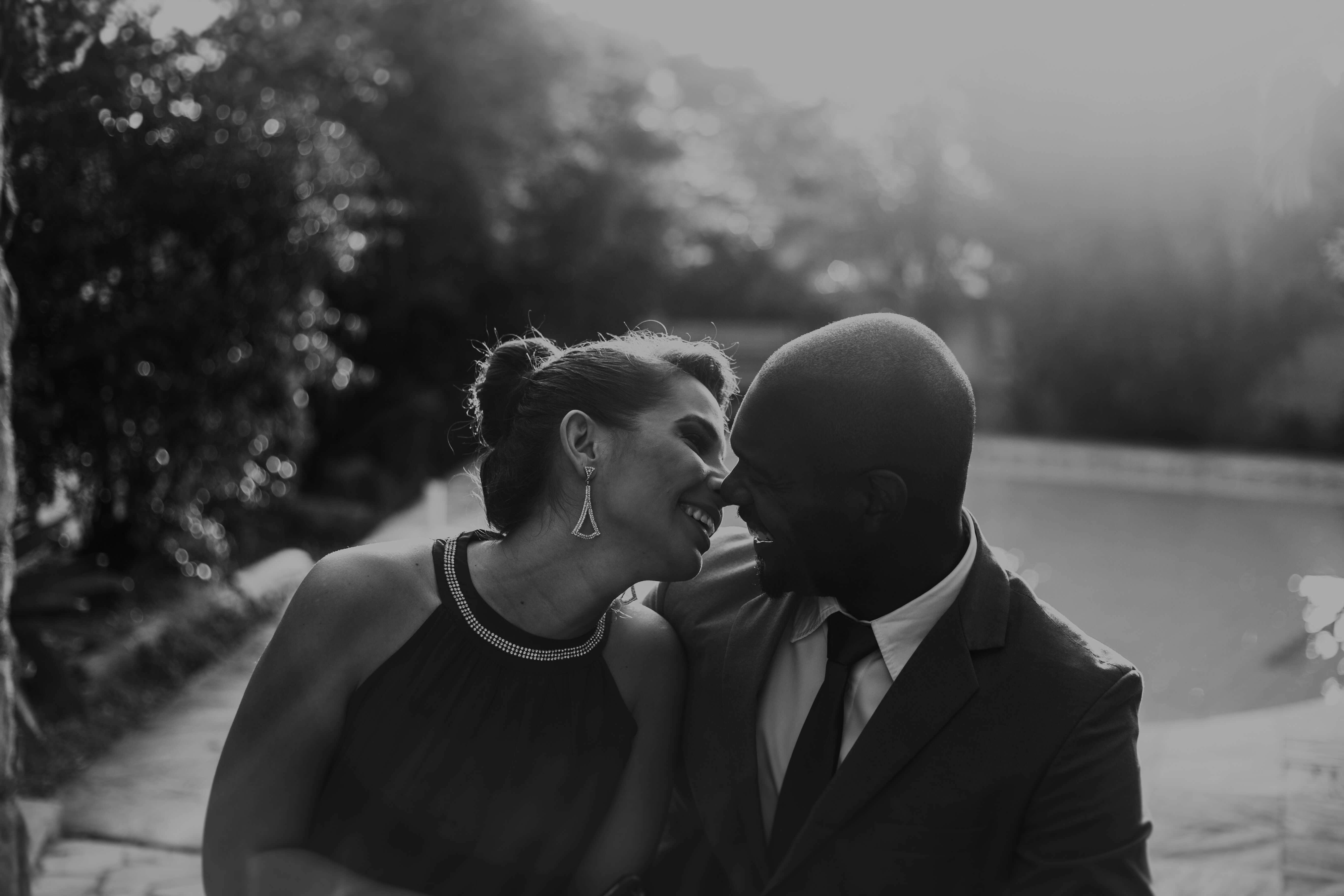 black and white photograph of a couple leaning in for a kiss 
