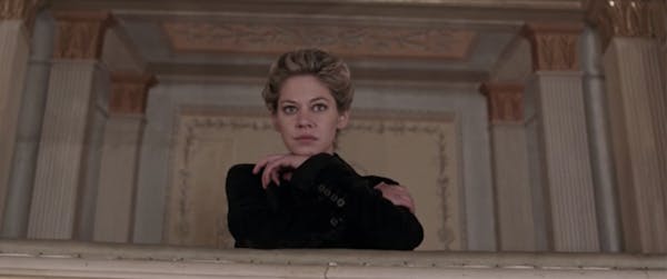 A woman leans on her arms in a scene from Compulsion