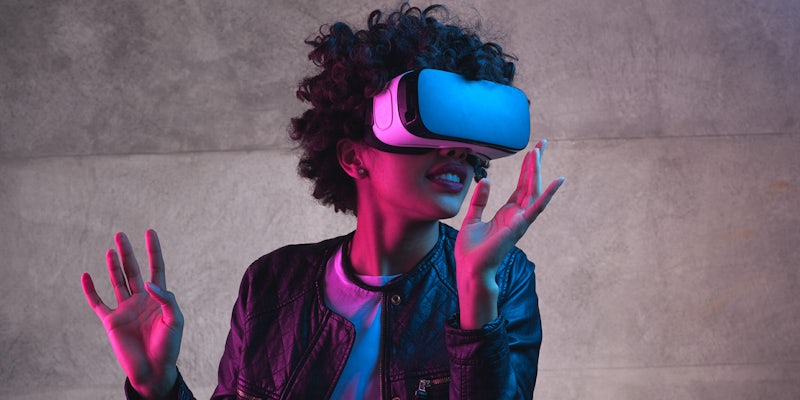 young woman using vr headset to play games