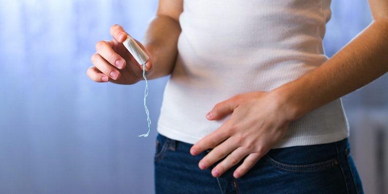 woman holding tampon