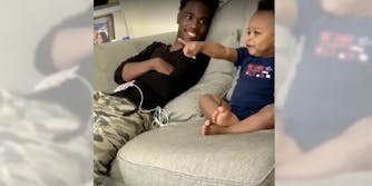 Dad and baby have a wholesome couch conversation.