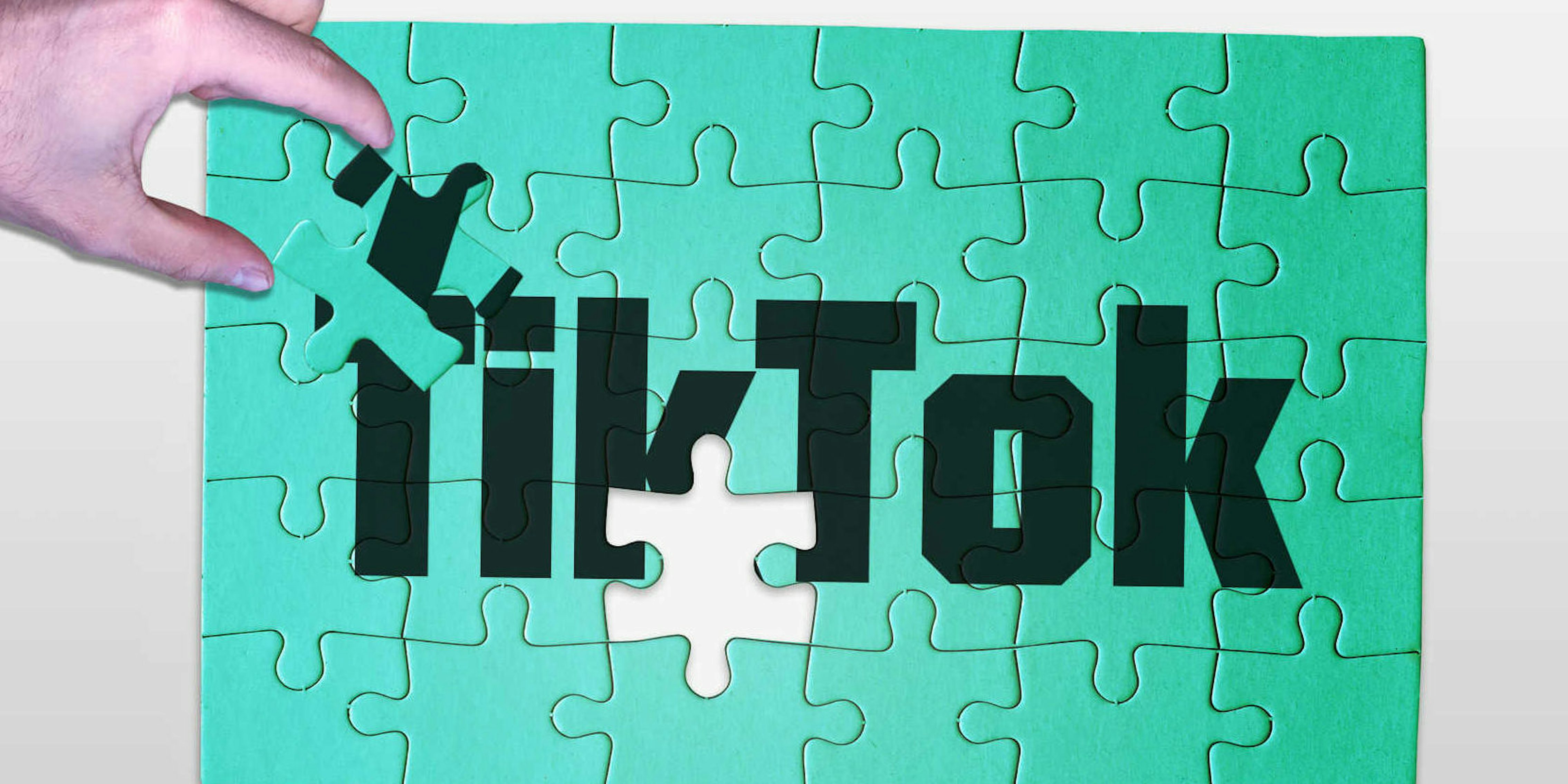 A hand shown completing a jigsaw puzzle with the text TikTok