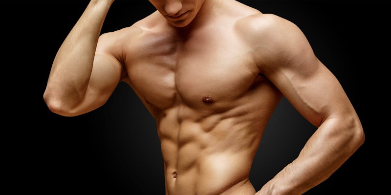 Male bodybuilder posing over black background