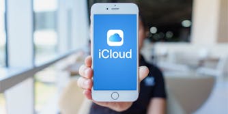 woman holding iphone with icloud logo on screen