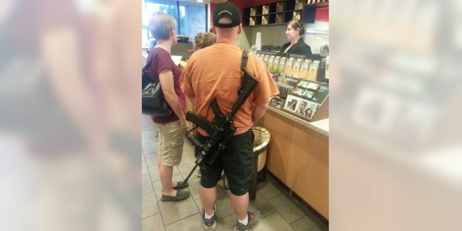 man carrying assault rifle in starbucks