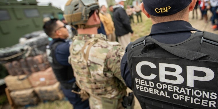 Customs and Border Protection officials wearing a hat and a jacket with the logo
