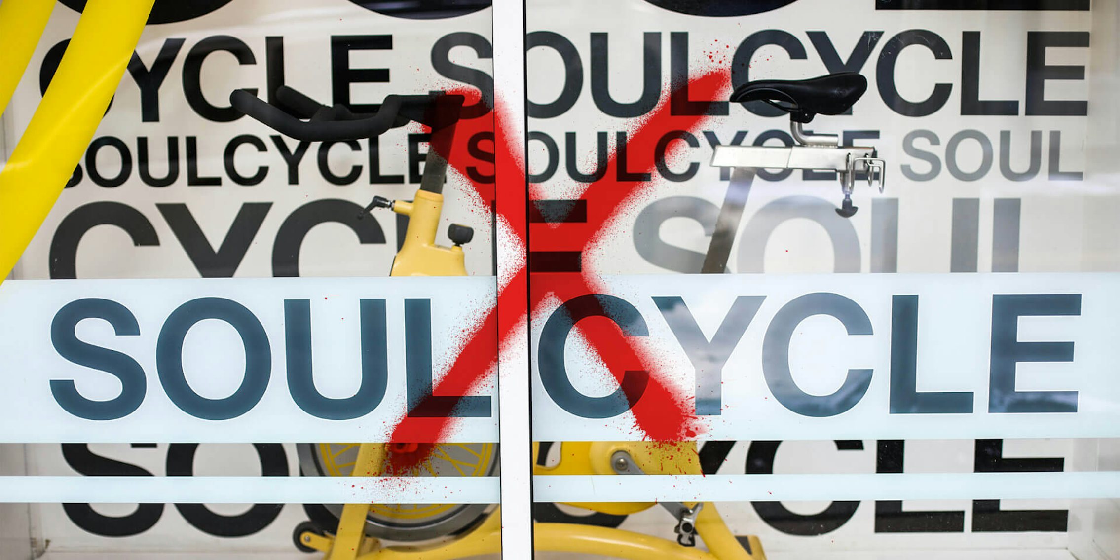 soulcycle store window spray painted with a red X
