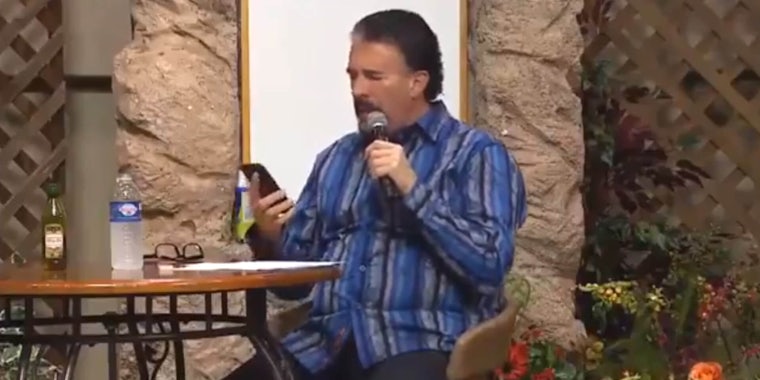 Perry Stone Jr pretending to speak in tongues as he checks his phone