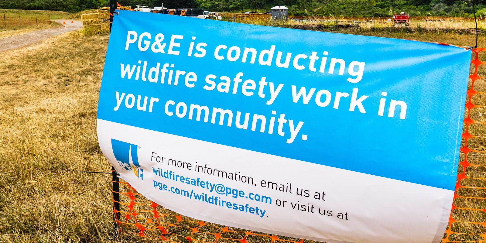 'pg&e is conducting wildfire safety work in your community' sign on construction fencing