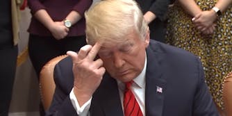 trump scratching his head with his middle finger during nasa phone call