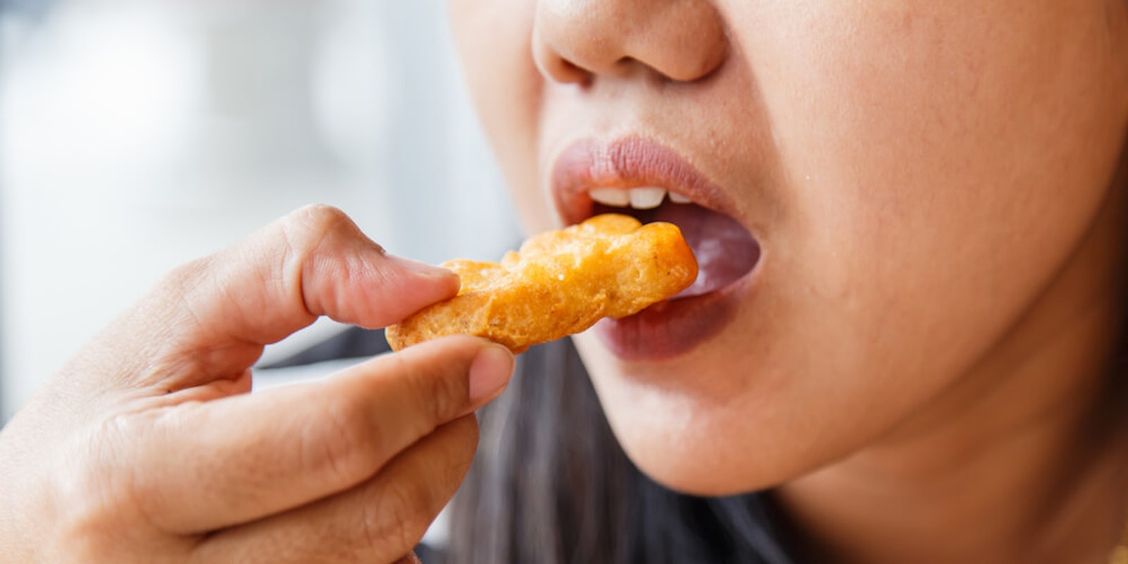 woman eating chicken nugget - vegan reddit am i the asshole