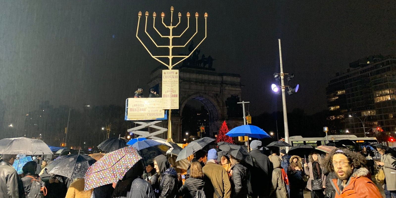 Photos showed members from the community braving the rain to sing and dance around the Menorah