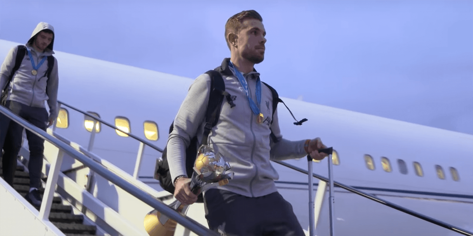 Jordan Henderson leaves plane with FIFA Club World Cup trophy
