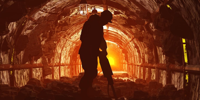 silhouette of miner in shaft