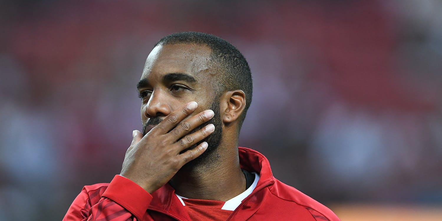 Alexandre Lacazette covering mouth with hand pre-match