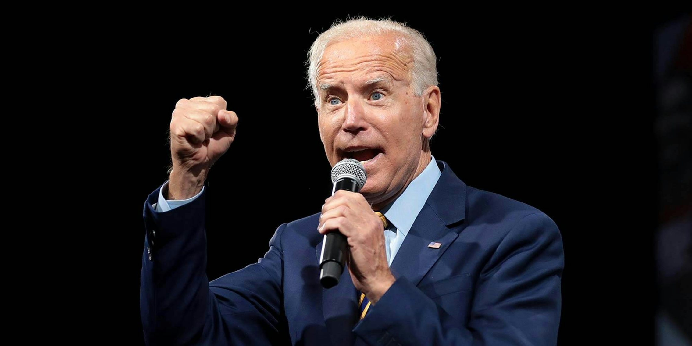 Joe Biden holding a microphone and speaking