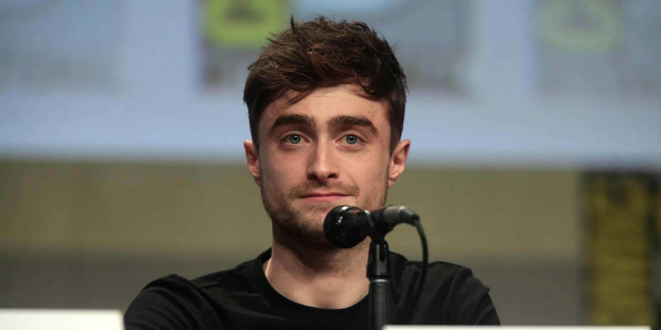 Actor Daniel Radcliffe in front of a microphone